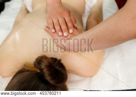 Top View Picture Of A Female Back, Masseur Making Massage Using Hands To Preassure With Them On Woma