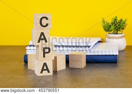 Capa Word Written On Wooden Cubes With Copy Space, Yellow Background. Capa - Short For Corrective An