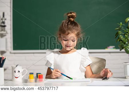 Child Girl Drawing With Coloring Pens Paintind. Portrait Of Adorable Little Girl Smiling Happily Whi