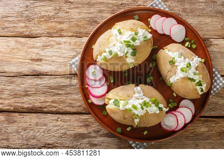 Boiled Jacket Potatoes Stuffed With Cottage Cheese, Sour Cream And Green Onions Close-up In A Plate 