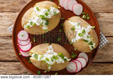Homemade Potatoes Stuffed With Salted Cottage Cheese, Sour Cream And Green Onions Close-up In A Plat