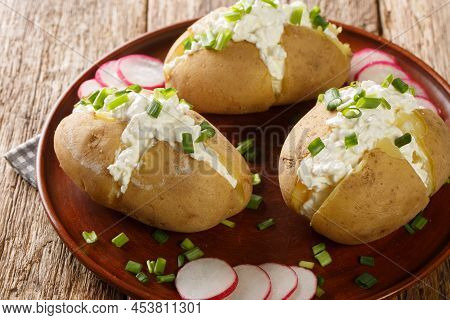 Delicious Potatoes With Cottage Cheese, Sour Cream And Green Onions Close-up In A Plate On A Wooden 