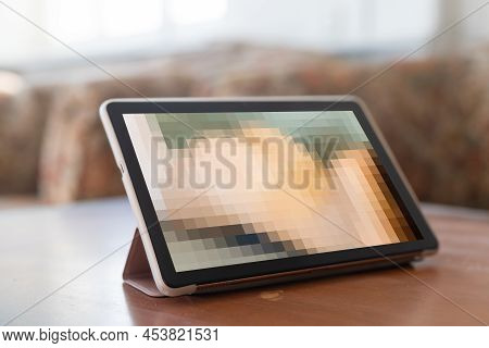 Closeup Of A Young Caucasian Man Watching A Nude Woman In His Tablet Computer