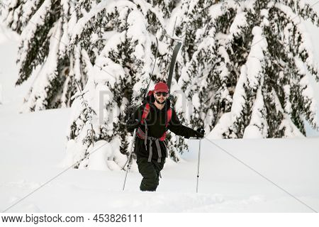 View Of Man In Black Jacket With Ski Tour Equipment.
