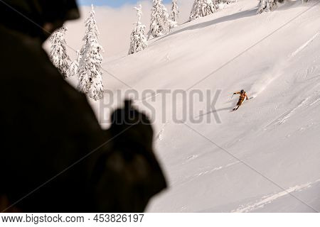 Great View Of Active Athlete Riding Down Snow-covered Mountain On Splitboard