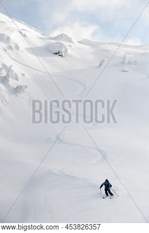 Great View On Snowboarder Riding Down The Untouched Powder Snow.