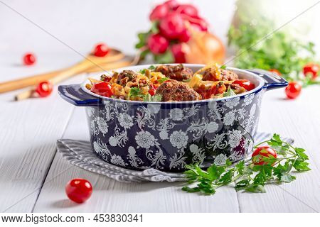 Homemade Meat Meatballs With Stewed Vegetables With Fresh Parsley In A Ceramic Pot On A Linen Napkin