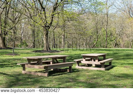 Two Picnic Tables In A Field In Frick Park, Located In Pittsburgh, Pennsylvania, Usa On A Sunny Spri