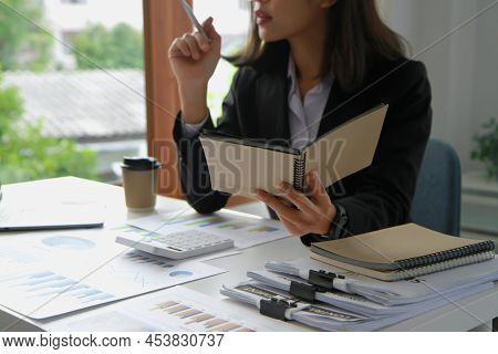 Financial Advisor Calculating Numbers Datasheets Graphs Charts Reports Marketing Research Developmen