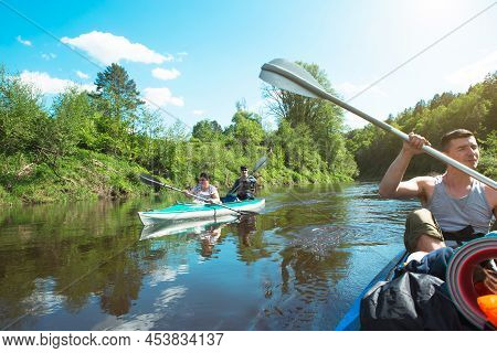Family Kayak Trip. Father And Daughter, And Elderly Couple Senior And Seniora Rowing Boat On The Riv