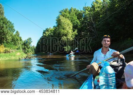 Family Kayak Trip. Father And Daughter, And Elderly Couple Senior And Seniora Rowing Boat On The Riv