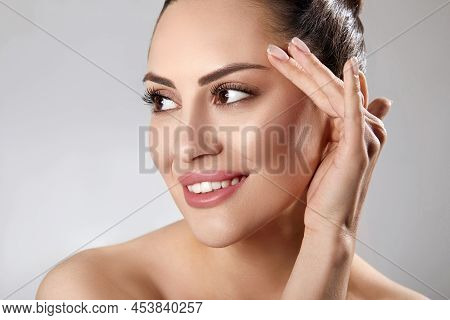 Skin Care. Woman With Beauty Face Touching Healthy Facial Skin Portrait. Beautiful Smiling Girl Mode