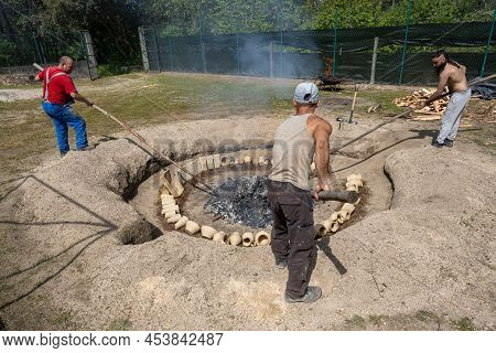 Amarante, Portugal - April 30: Three Men Carry Out The Phase Of Opening The Embers In The Process Of