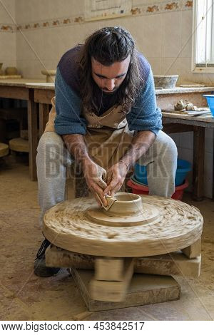 Amarante, Portugal - April 30: Potter Shaping A Piece Of Clay On A Low Wheel On April 30, 2022 In Am