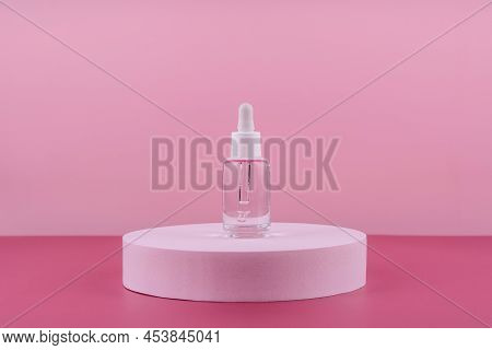 Serum Cosmetic Bottle With Peptides And Retinol On Platform Pedestal On Pink Background. Hyaluronic 