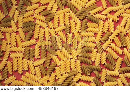 Dry, Undercooked, Colored Pasta On A Bright, Light, Even Canvas.