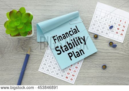 Finansial Stability Plan. Text On A Blue Sticker On A Torn Calendar.