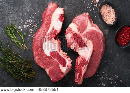 Raw Beef Meat. Rough Piece Of Meat On Bone For Roast Or Soup With Salt, Pepper, Thyme And Rosemary O