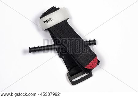Hemostatic Tourniquet On A White Background Top View. A Tourniquet To Stop Bleeding. Bandaging The W