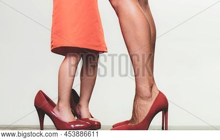 Girl Growing, Wearing Mothers High Heel Shoes. Girl Dreaming About Fashionable Highheels. Kids Shoes