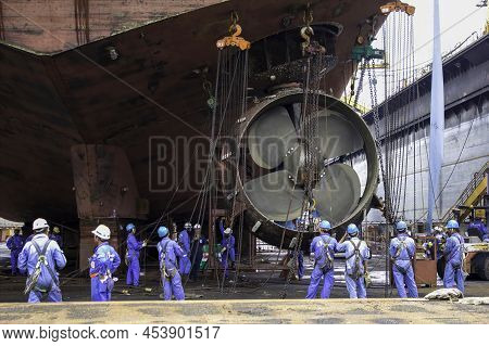 Sembawang, Singapore - Mar 2 2013: Sembawang Ship Yard Workers Changing Stern Nozzle Azipod Thruster