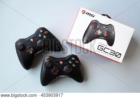Two Msi Joystick Gaming Controller On Light Blue Background.