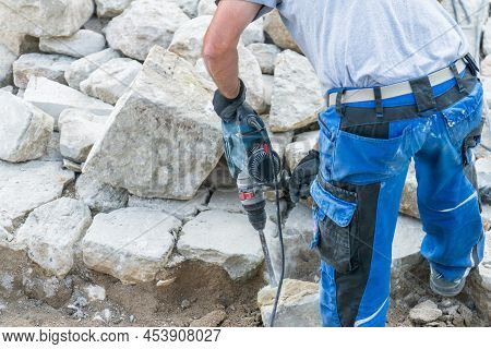 Construction Worker Is Working With Granite Stones