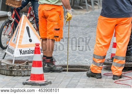 Street Works On Sewer Channel  With Warn Sign In German Words For Channel Works