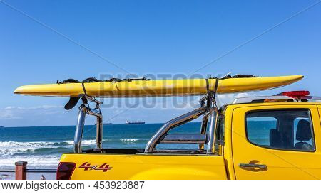 Beach Blue Ocean Close-up Rescue Surf Paddle Craft Strapped On Emergency Vehicle On Standby With Lif