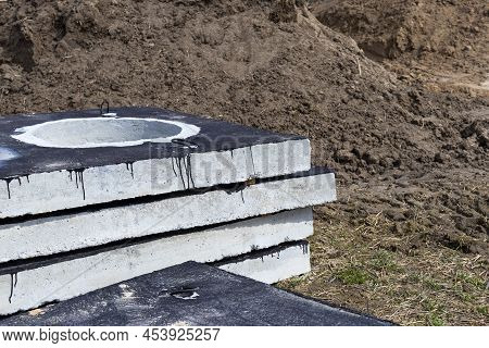Reinforced Concrete Slabs At A Construction Site Against A Blue Cloudy Sky And Earth. Folded Plates 