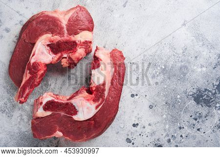 Raw Beef Meat. Rough Piece Of Meat On Bone For Roast Or Soup With Salt, Pepper, Thyme And Rosemary O