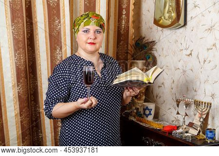 A Jewish Woman In A Headdress With A Glass Of Avdala Wine And A Siddur In Her Hands. Horizontal Phot
