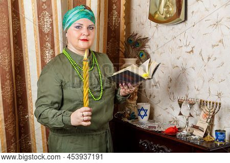 A Jewish Woman In A Headdress With Awdala Candles And A Siddur In Her Hands. Horizontal Photo