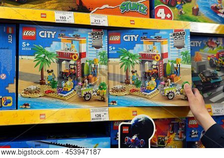 Woman Chooses Lego As A Gift For A Child Closeup. Large Selection Of Lego Toys. Lego Is A Popular Li