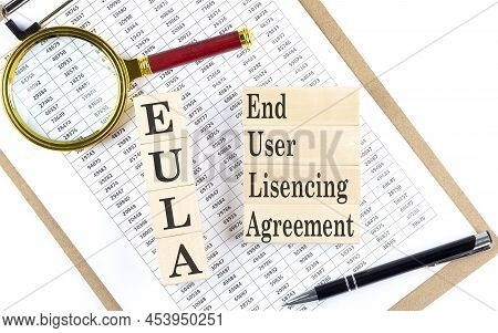 Eula - End User Licensing Agreement Text On Wooden Block On A Chart Background