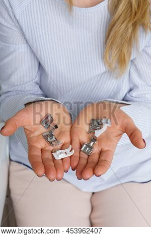 Seamstress Holds Sewing Machine Parts In Hands. Presser Foot Accessories In Tailor Hand. Dressmaker 