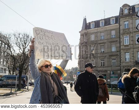 Strasbourg, France - Mar 6, 2022: Woman Holding Placard Against Putin As Hundreds Of Demonstrators G