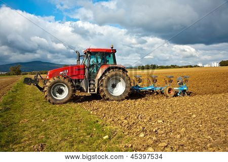 ESCHBORN, GERMANY - MAY 3, 2012: tractor with plow on field in bad weather