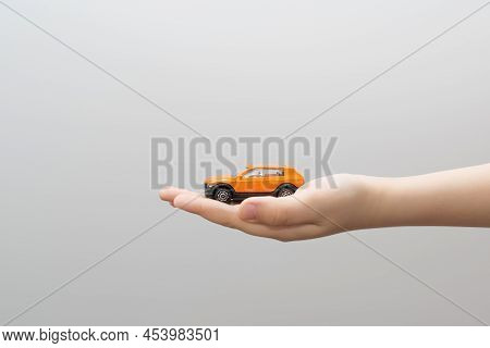Small Metal Model Toy Car In Child Hand.