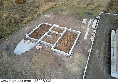 Top Down Aerial View Of Building Works Of New House Concrete Foundation On Construction Site