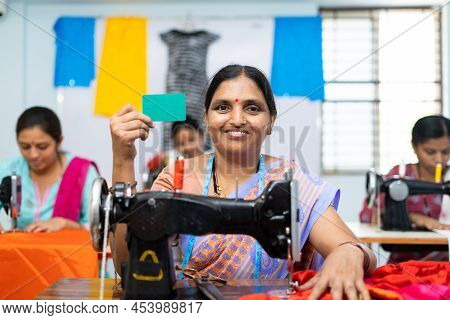 Women Showing Green Screen Empty Card By Looking At Camera While Working At Seawing Maching At Garme