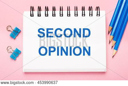 On A Light Pink Background, Light Blue Pencils, Paper Clips And A White Notebook With The Text Secon