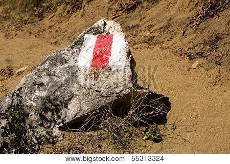 Tourist path mark on a stone