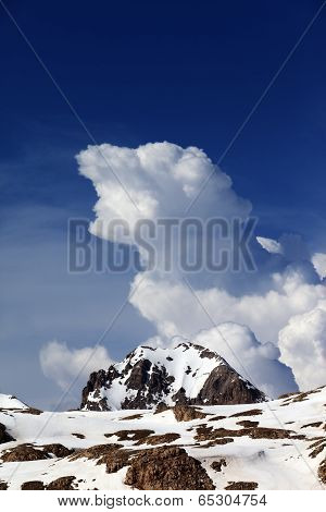Rocks In Snow And Blue Sky With Clouds