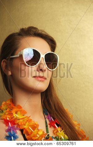 Girl with sunglesses and hawaiian wreath