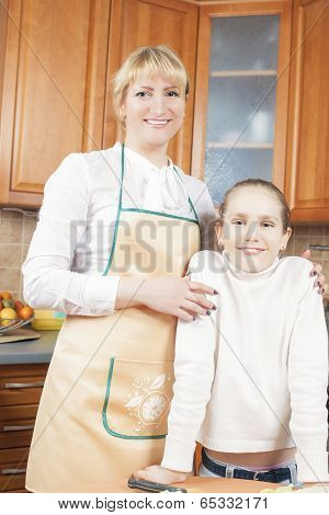 Mother And Daughter Together In The Kitchen