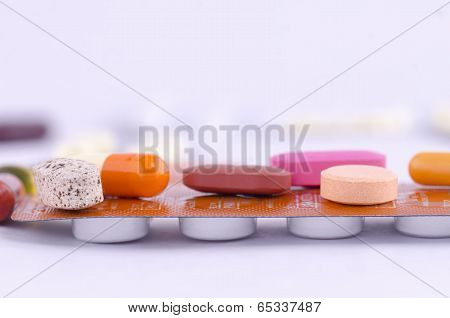 Colorful drugs on top a packed medication