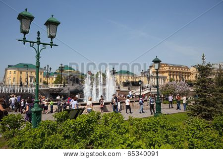 People Walking Around Horses Fountain