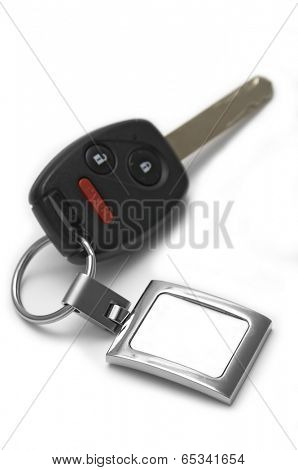 Car key with wireless remote and panic button button showing a blank tag for custom text - Shallow depth of field!
