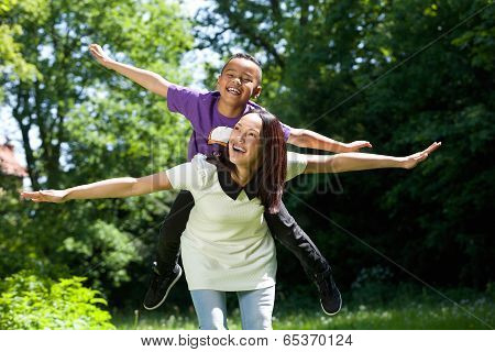 Mother And Son Pretending To Fly